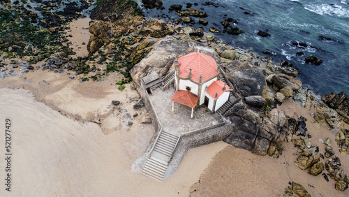 Vista aérea de drone sobre a Capela do Senhor da Pedra na praia de Miramar, Gulpilhares, Vila Nova de Gaia - Portugal photo