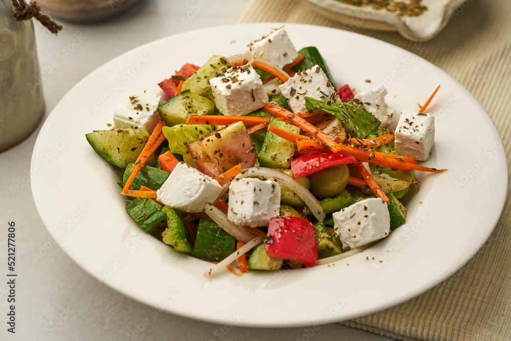 Greek Salad with cucumber, tomato, carrot served in a dish isolated on grey background side view of healthy food Greek Salad with cucumber, tomato, carrot served in a dish isolated on grey background side view of healthy food