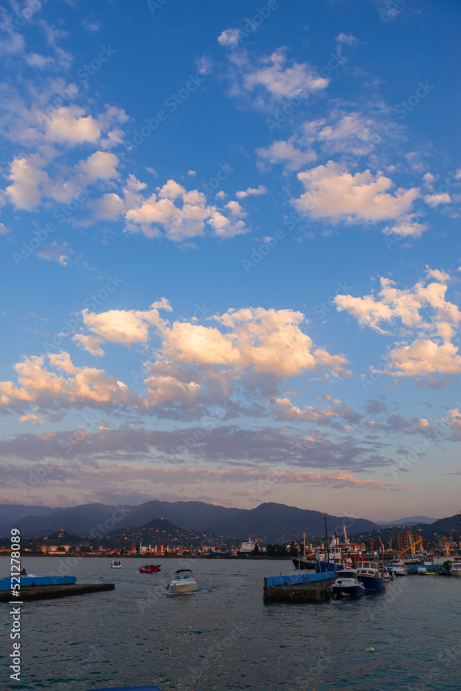 Fototapeta premium Beautiful sunset and small ships in Batumi sea port