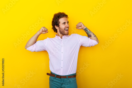 Cheerful male manager showing muscles