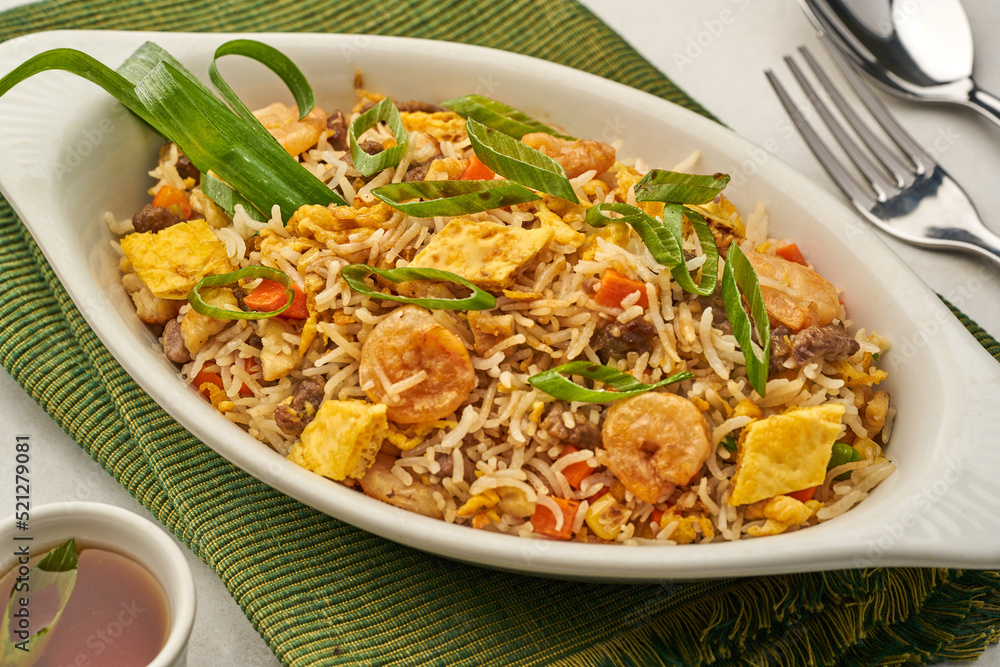 Mixed Fried Rice served in a dish isolated on grey background side view of fastfood Mixed Fried Rice served in a dish isolated on grey background side view of fastfood