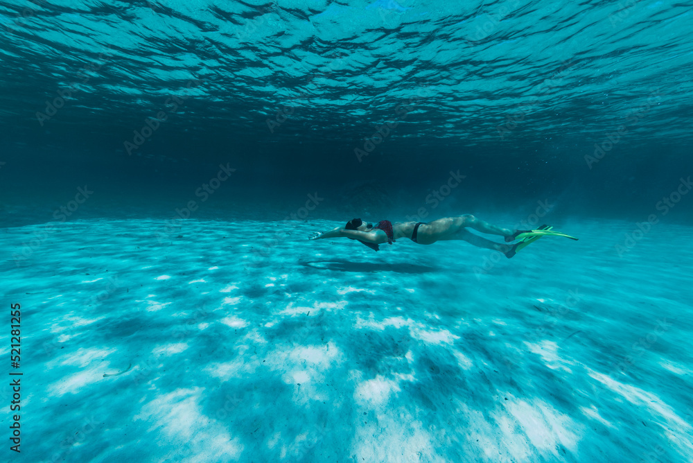 a girl swims underwater