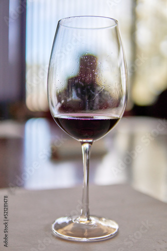 glass of red wine in the foreground with the background out of focus in a winery in Mendoza Argentina. Wine tasting. Selective focus
