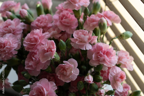 Fototapeta Naklejka Na Ścianę i Meble -  Beautiful Pink flower arrangement in a stylish vase scandi style home interior. Spring flowers.
