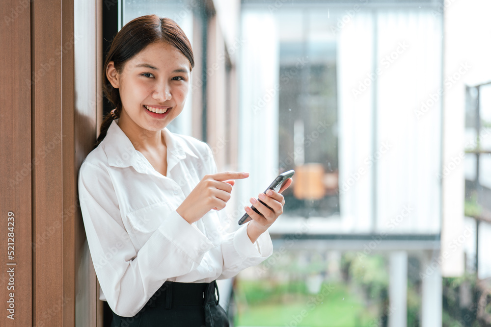 Business woman working on smartphone in office space. Business woman working on smartphone in office space.