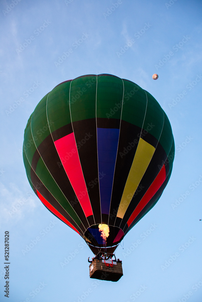 Fototapeta premium Colorful hot air balloon rising in the sky