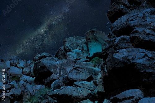 Low-angle view of rocks at night under the milkiway starry sky photo