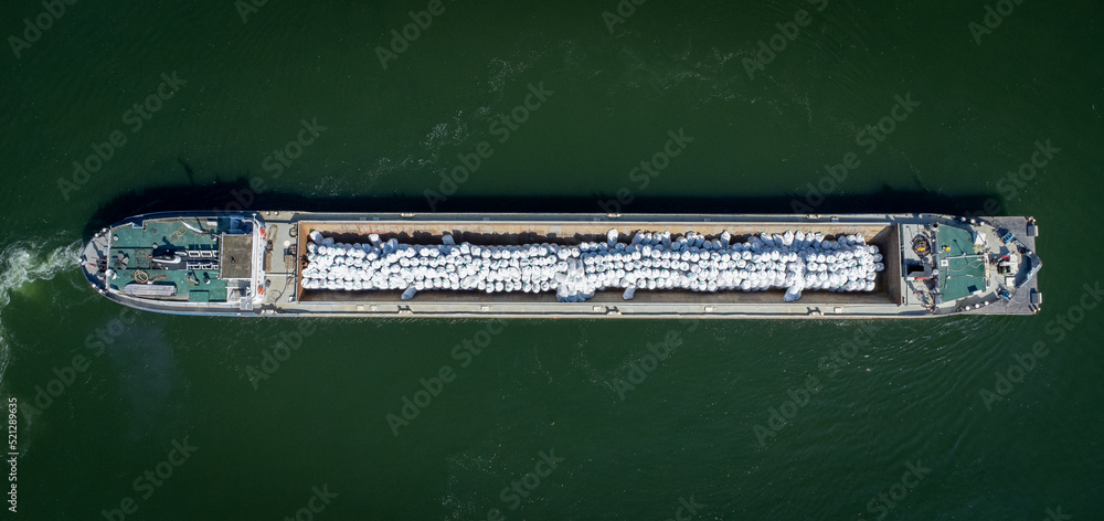 Ship making a turn on Danube River near Vidin, Bulgaria shot with a drone from above
