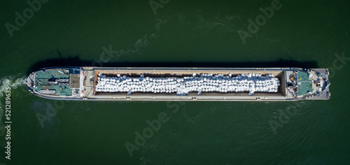 Ship making a turn on Danube River near Vidin, Bulgaria shot with a drone from above © lubo