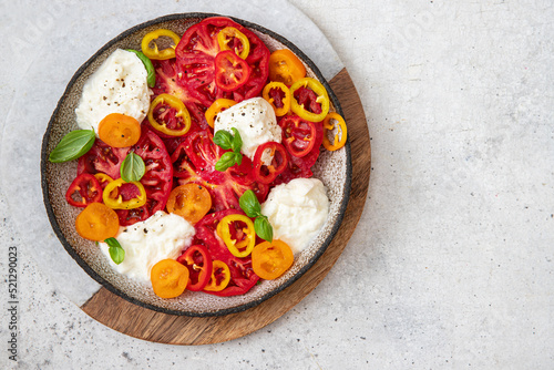 Salad with tomato, Bell pepper , basil and burrata cheese	