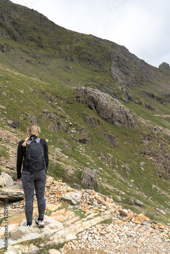 Woman Hiking on Pyg miners track Snowdonia Mountain Snowdonia National Park North wales female .