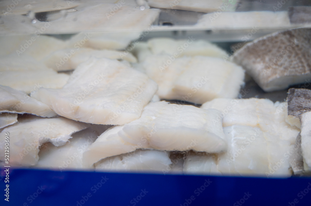 White salted and dried bacalao codfish is watertank, traditional Spanish food on display in fish shop