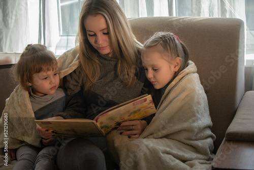 family spends leisure time at home reading a book