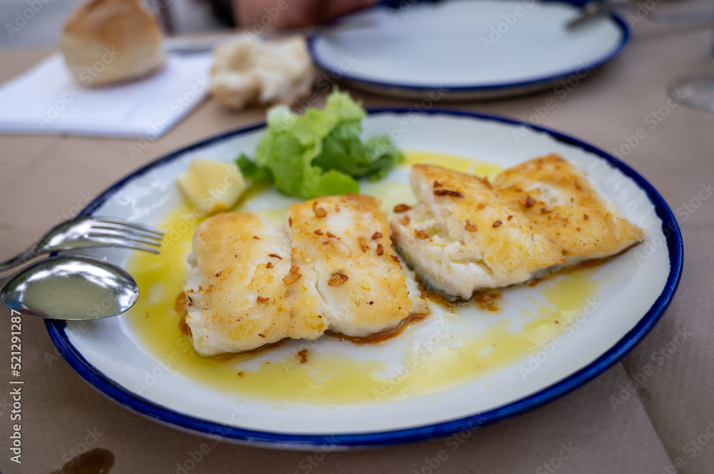Grilled fillet of white codfish served in fish restaurant in San Sebastian, Basque Country, Spain Grilled fillet of white codfish served in fish restaurant in San Sebastian, Basque Country, Spain