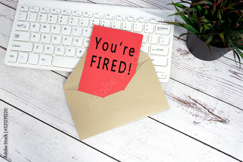 You are fired text on red note inside brown envelope.