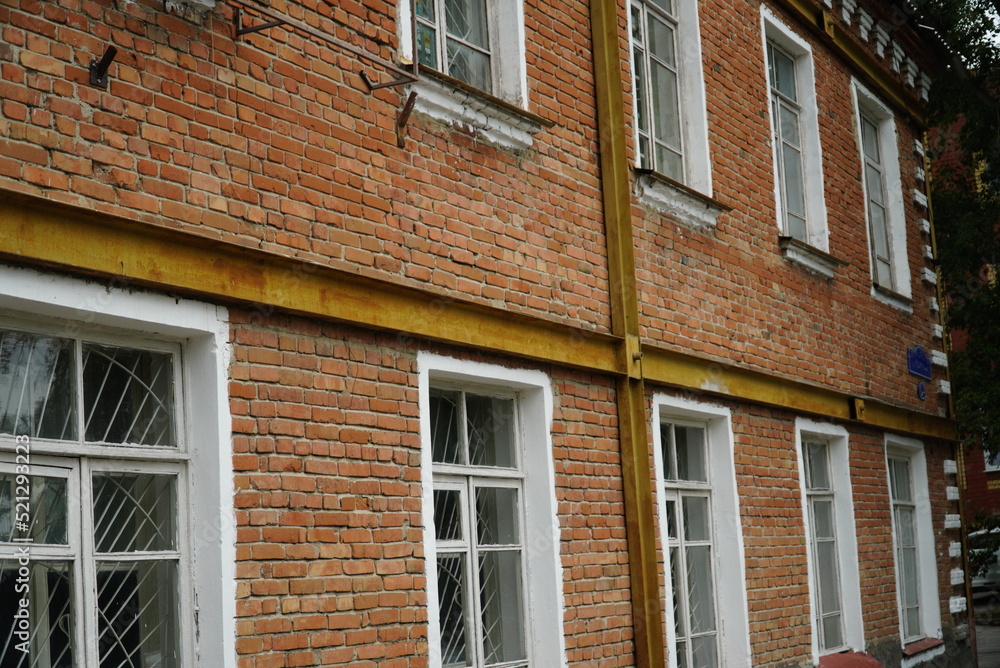 Building with reinforced wall, strengthen old brick wall structure. Renovation and restavration of old facade