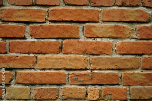 Fragment of a ceramic brick wall with white masonry mortar  white masonry seams  close-up