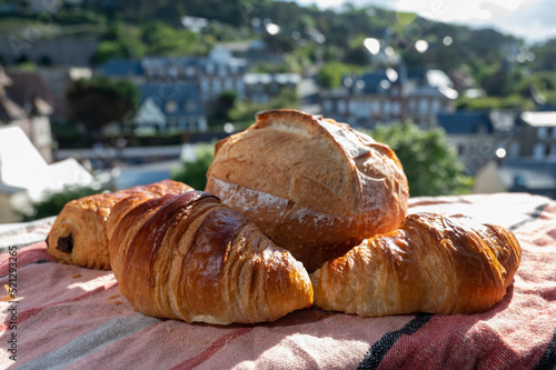 Two fresh baked butter croissants and whitre wheat farmers breasd from French bakery photo