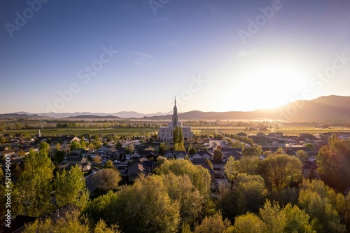 Aerial view of Payson Utah Temple in the middle of trees and houses under the blue sky photo