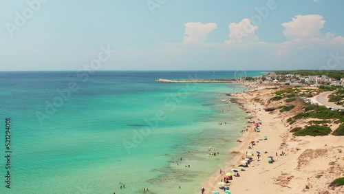 Spiaggia di Campomarino di Maruggio (Salento, Puglia) in estate, vista dal drone, con la ruota panoramica sullo sfondo photo