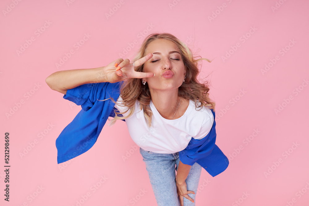 Portrait of pretty cheerful girl dancing in good mood isolated on pink background Portrait of pretty cheerful girl dancing in good mood isolated on pink background