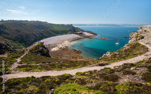 Beautiful view of Port-Blanc cove ("anse de Port-blanc" in french) next to Cape Erquy with Saint Brieuc bay in the background. Lovely scenic footpath in the foreground.
