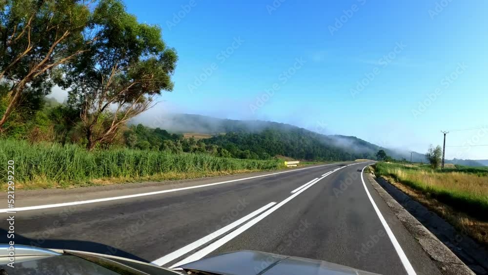 POV shot of driving a car on the road along the forest and mountains. Traveling in the summer by car POV shot of driving a car on the road along the forest and mountains. Traveling in the summer by car