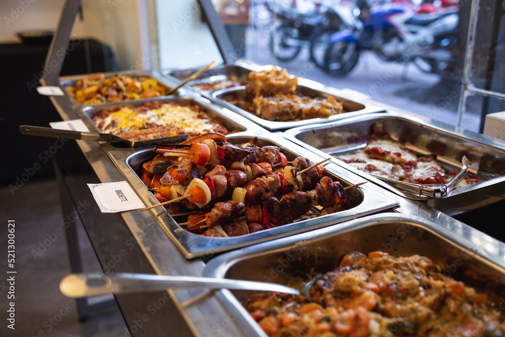 tray with different dishes of food in a buffet