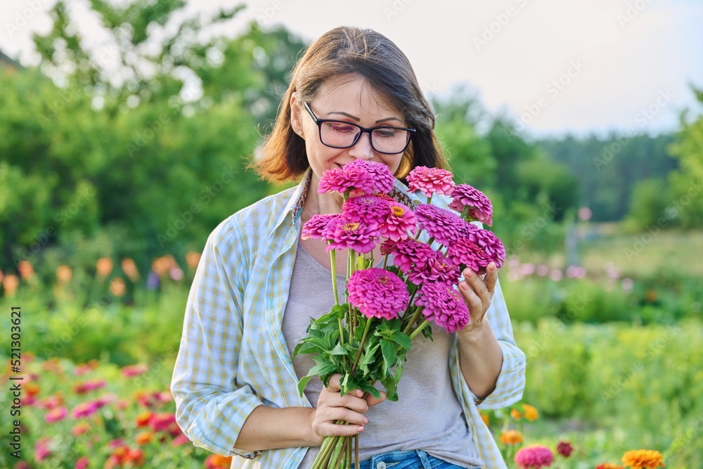 Portrait of a middle aged woman with a bouquet of flowers outdoor Portrait of a middle aged woman with a bouquet of flowers outdoor