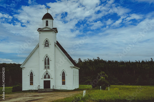 Small Church by the road in Nova Scotia, Canada with white siding, bell tower, arched stained glass windows.  Edited to create a post-modern graphic artwork. 