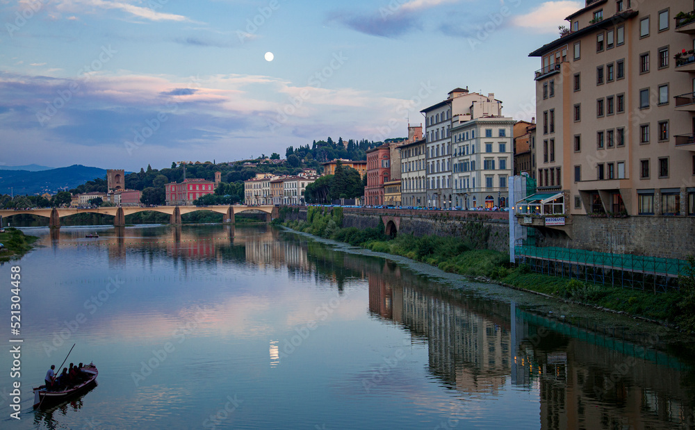 Romantic gondola ride down the river in Florence during a full moon