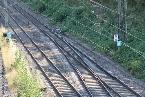 Railway tracks switch, railroad with electricity and two tracks, rails gravel trains wires