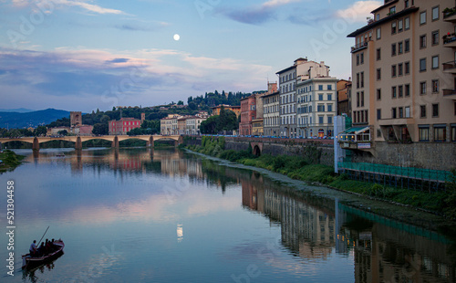 Romantic gondola ride down the river in Florence during a full moon