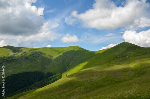 Steep green grassy slope on the mountain ridge in a scenic landscape conceptual of travel and vacations. Carpathian Mountains, Ukraine