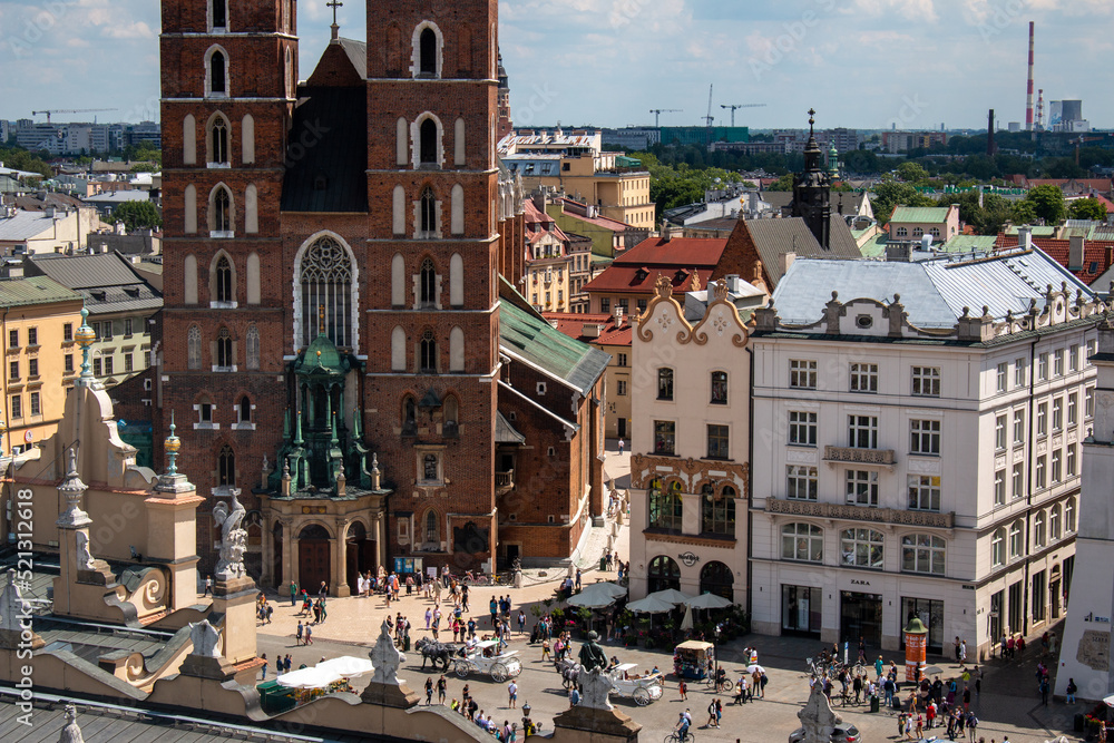 Krakow, Poland, July 15th 2022 - St. Mary's Basilica and the market square in the old city center, the view from the Town Hall Tower.