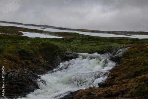 A stream of water from the melting snow along the hiking trail between Storulvans and Blahammaren Mountain Stations in Jamtland, Sweden