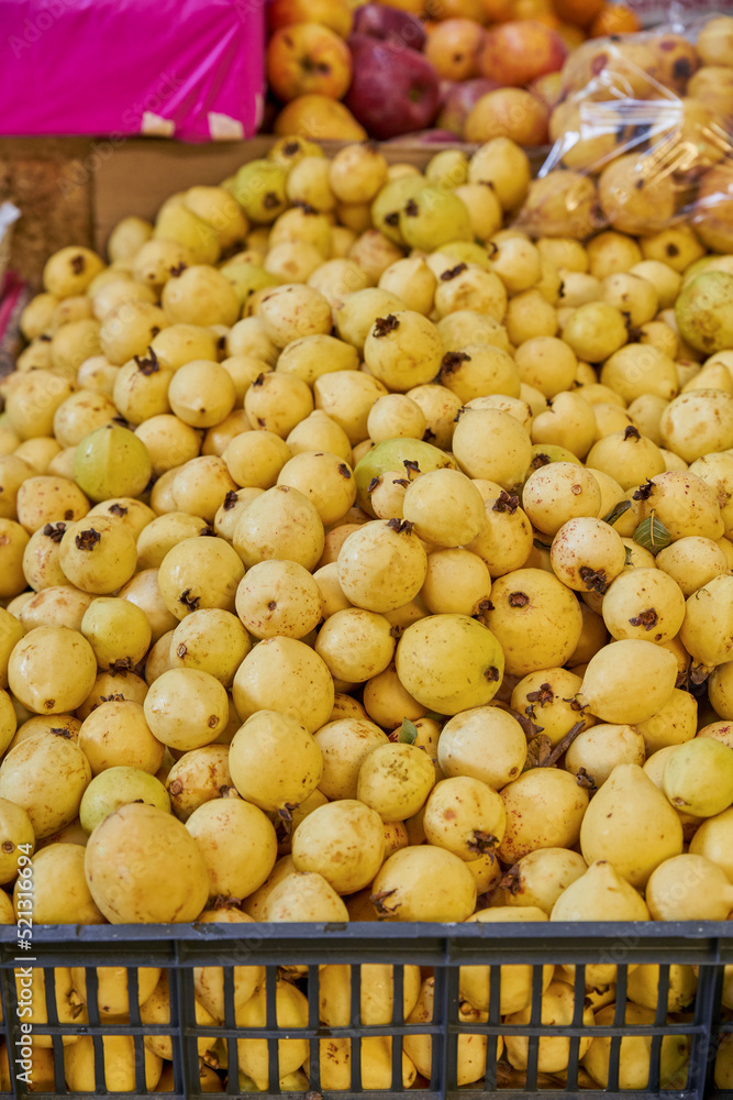 Juicy guavas placed on a shelf for sale inside a market Juicy guavas placed on a shelf for sale inside a market