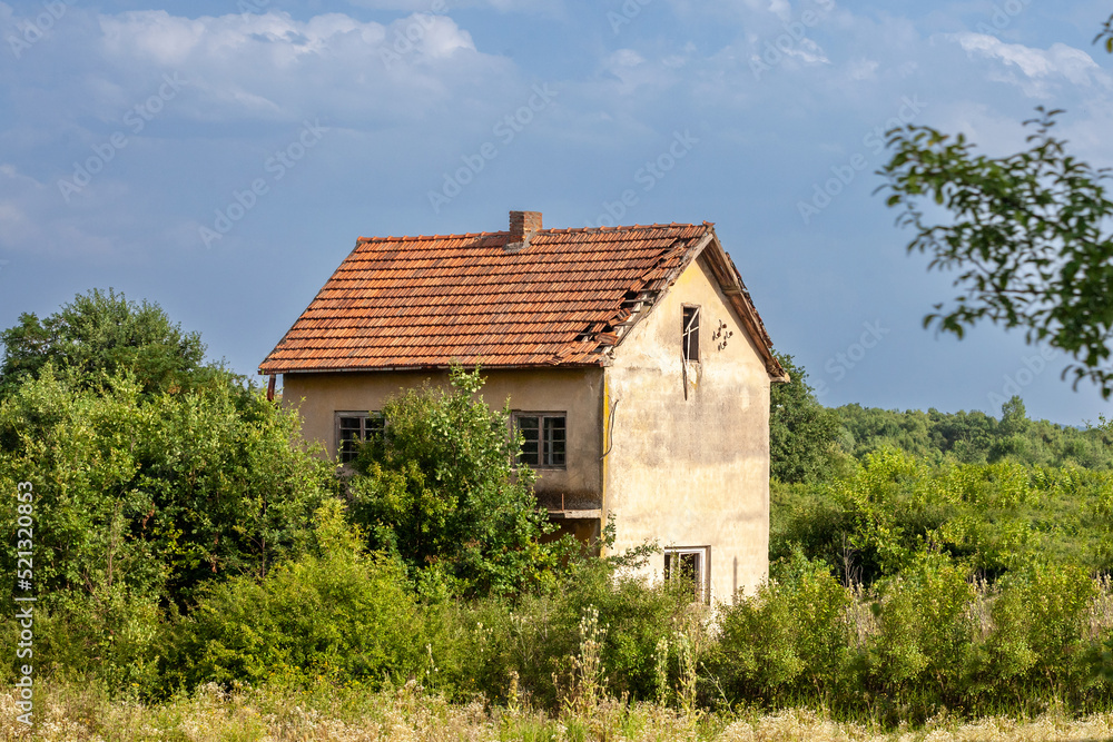 Old Residential house building from an abandoned farm in Serbia, in the middle of a rural countryside. The region of Balkans is hit by a severe rural exodus and emigration deserting the area.... Old Residential house building from an abandoned farm in Serbia, in the middle of a rural countryside. The region of Balkans is hit by a severe rural exodus and emigration deserting the area....