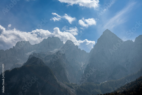 Fototapeta Naklejka Na Ścianę i Meble -  Selective blur on Triglav mounts in the Julian Alps, in Slovenia, by Bohinj, during a sunny afternoon in summer. Triglav vrh is the highest peak and mountain of Slovenia. .....