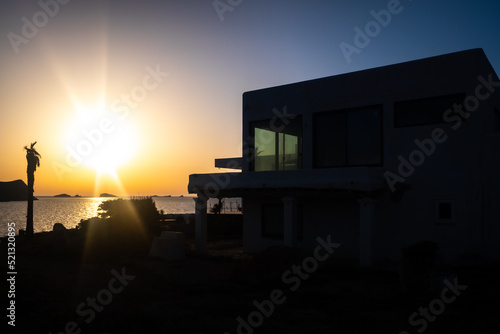 Sunset silhouette of a traditional Ibizan house