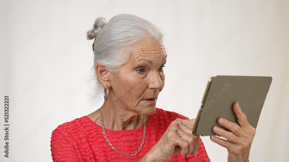Portrait of mature elderly woman posing holding phone video chat isolated on solid white background. Portrait of mature elderly woman posing holding phone video chat isolated on solid white background.