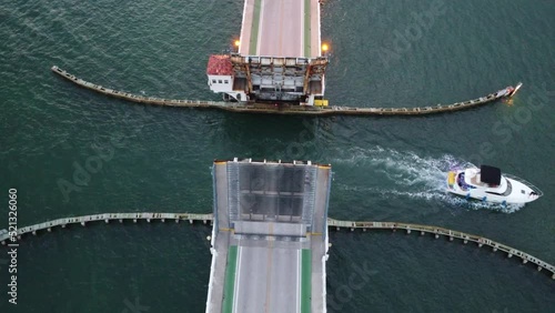 Drone footage above the drawbridge in MIA, FL boat travels and rotation around bridge photo