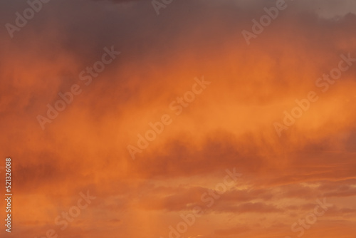 Puffy Orange Clouds Reflect Sunset LIght