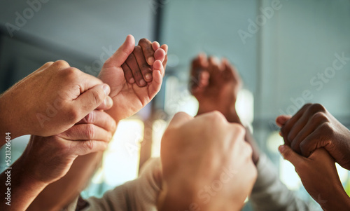 Diverse people holding hands in teamwork, success and support while showing solidarity, trust and unity in office. Closeup of business team, men and women standing together for equal workplace rights
