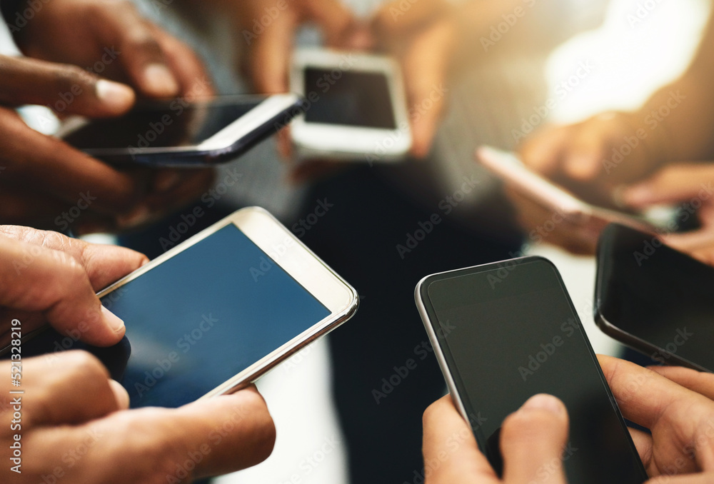 Closeup of business people hands typing on a phone, texting on social media or reading emails or online news. Diverse group of colleagues social networking, looking at copyspace mobile screens. Closeup of business people hands typing on a phone, texting on social media or reading emails or online news. Diverse group of colleagues social networking, looking at copyspace mobile screens.