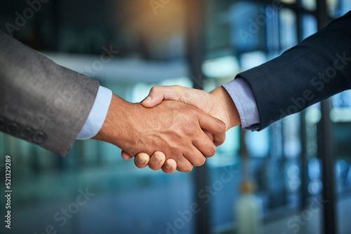 A handshake showing teamwork, collaboration and togetherness by business colleagues after a meeting in the office. A successful agreement has been reached by male coworkers in a business deal photo