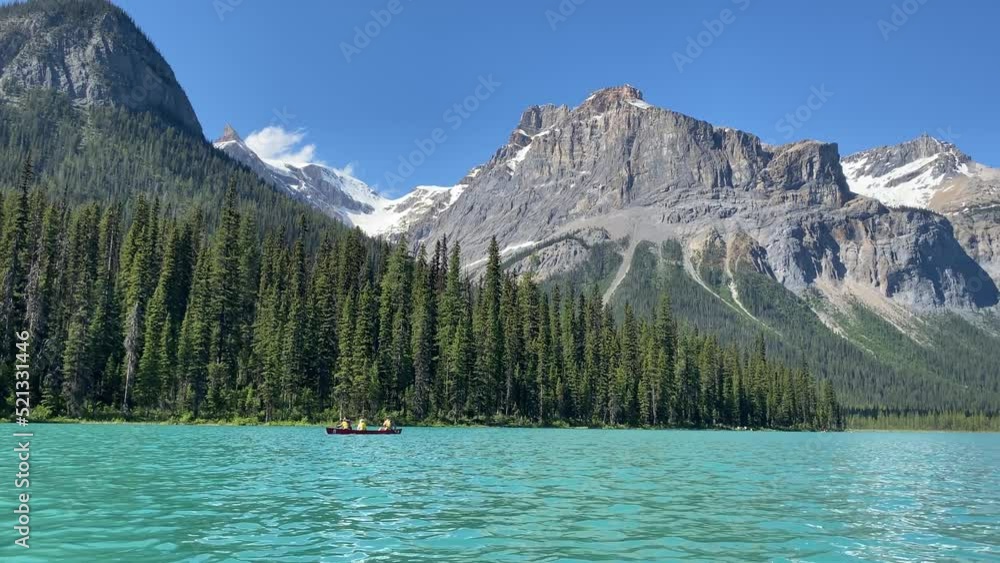 Emerald Lake in Yoho National Park as tourists use canoes on the lake Emerald Lake in Yoho National Park as tourists use canoes on the lake