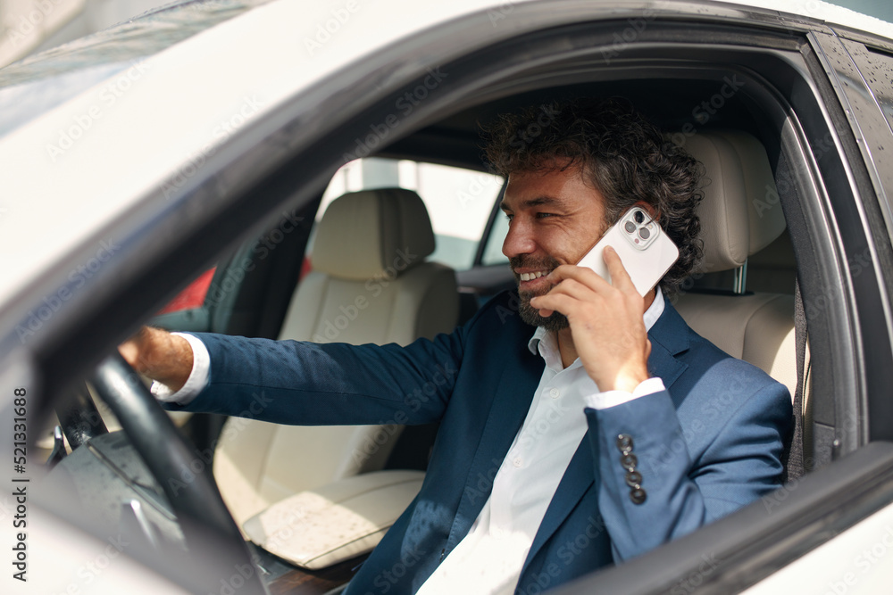 Closeup Caucasian Man Picking Up Phone at Car. Focused Positive Man Talking Smartphone at Automobile. Businessman Using Mobile Phone 