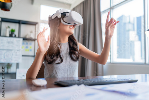 Creative Asian female woman wearing smart virtual glasses and joining business meeting on augmented reality metaverse working space,asia woman using a VR to explore virtual space video conference 