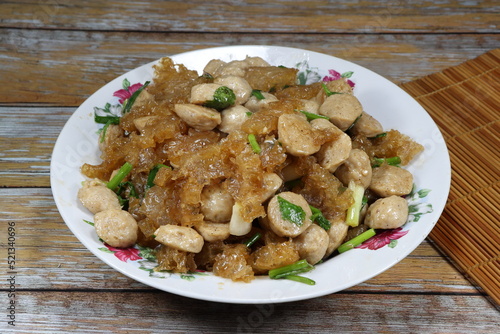 Traditional fried fresh pork skin with pork ball serving on the plate. Famous ancient menu in Chinese restaurant.